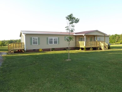 Convenient side entry to house. Welcoming front porch and beautiful landscaping!