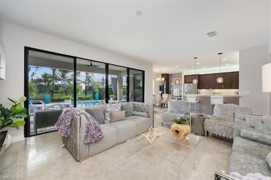 Living room with a chandelier, recessed lighting, and light tile patterned floors