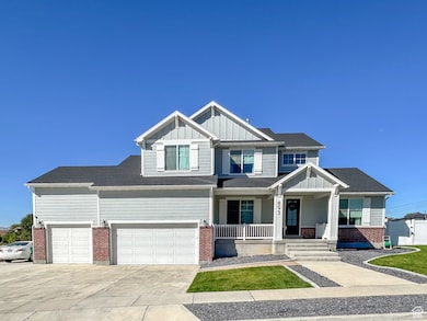 Craftsman-style home with board and batten siding, a porch, driveway, a garage, and brick siding