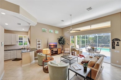 Living area featuring visible vents, baseboards, l