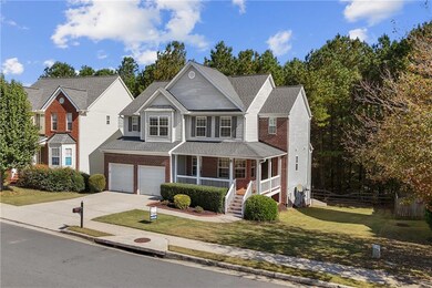 Traditional home featuring covered porch, concrete driveway, brick siding, stairway, and roof with shingles