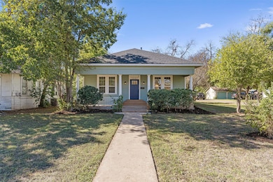 Bungalow with a porch, a front lawn, and roof wit