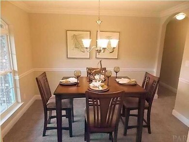 Formal Dining Room with Crown Molding and Chair Rail