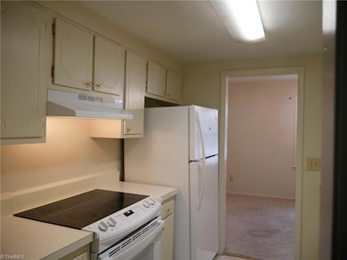 Galley kitchen with new built-in range plus new range hood.