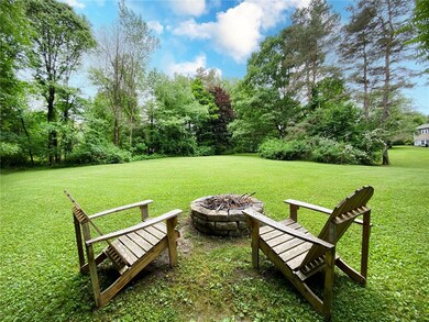 Over 3 acres of park like grounds with fire pit.