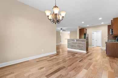 Kitchen with hanging light fixtures, ceiling fan w