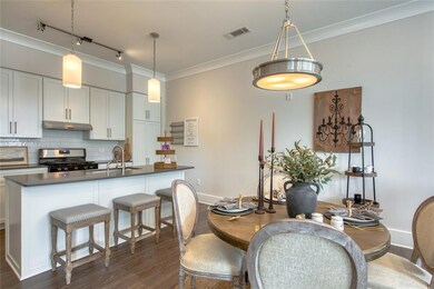 Dining area with sink, dark wood-type flooring, tr