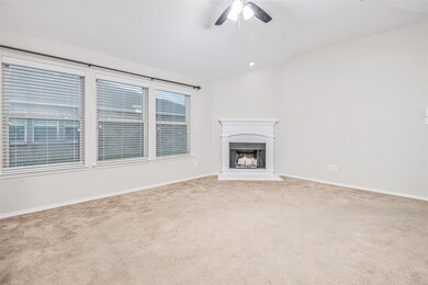 Unfurnished living room with carpet floors and ceiling fan