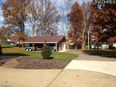 view of outbuilding and back yard with carport or 