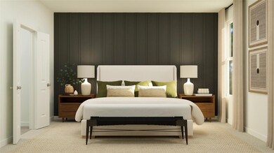 Bedroom featuring an accent wall, light colored ca