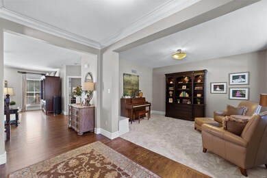 Foyer opens to inviting living room with neutral d