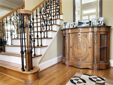 Staircase with baseboards and wood finished floors