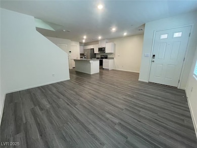 Unfurnished living room featuring dark wood-style