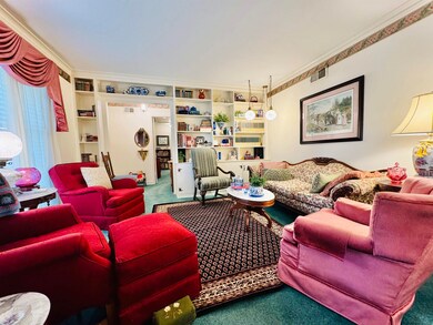 Living room featuring crown molding and carpet flo