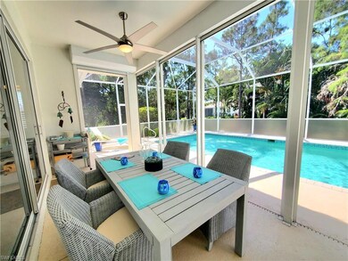 View of pool featuring ceiling fan, glass enclosur