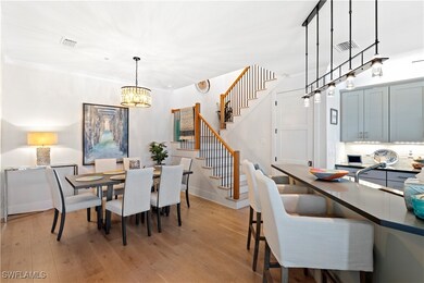 Dining area featuring a chandelier, stairs, and li