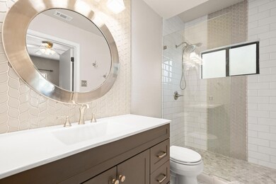 Your en-suite is stunning, featuring ornate tiles, a single extended vanity, and an expansive walk-in shower. 