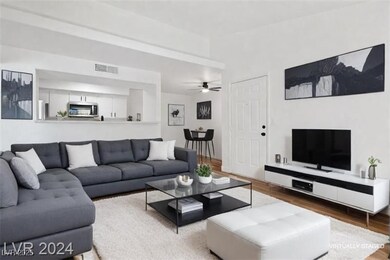 Living area featuring wood finished floors and a ceiling fan
