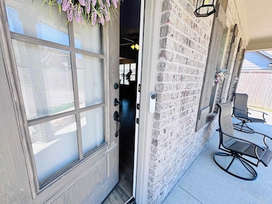 Entrance to property featuring brick siding