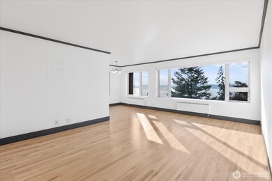 Light Filled living and dining with gleaming hardwood floors and fresh paint. All windows overlook the Puget Sound or Mt Rainier.