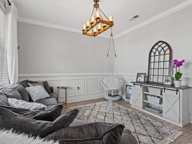 Interior space featuring an inviting chandelier, hardwood / wood-style flooring, and ornamental molding