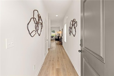 Hallway featuring light hardwood / wood-style floo