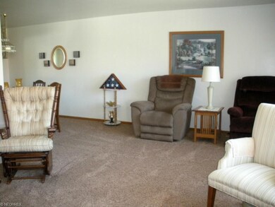 Lovelyliving and dining room (L shaped).  Newer carpet, hardwood underneath.