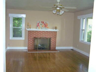 Large den with hardwood floors and gas fireplace.