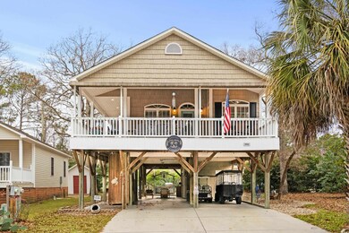 Beach home featuring a porch and a carport