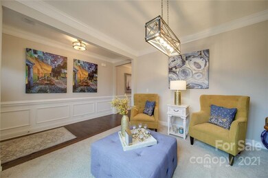 Notice the updated light fixtures, beautiful wainscoting and hardwood floors.