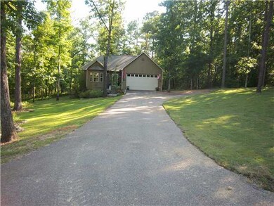 Driveway to double garage and parking pad.