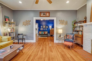 Living area with light wood-style flooring, ornamental molding, recessed lighting, baseboards, and ceiling fan