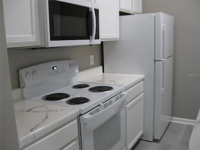 KITCHEN SHOWING RANGE, REFRIG, MICROWAVE