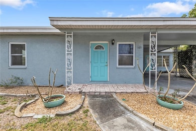 View of exterior entry with an attached carport an