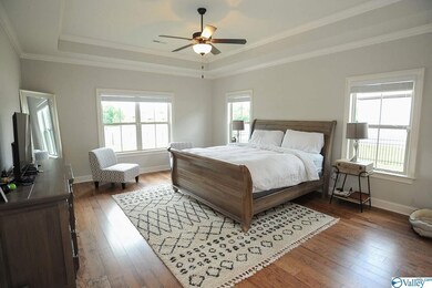 Owners suite includes trey ceilings, wood floors and abundant natural light.  Wake up to lake views every day.