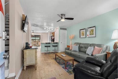 Living room featuring light wood-style floors, cei