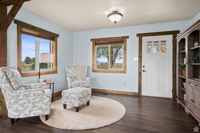 Sitting room with dark wood-style flooring
