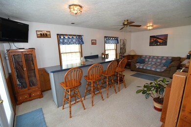 Kitchen opens to the family room with built in bar