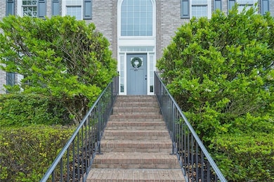 View of exterior entry featuring brick siding