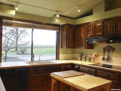 Spacious kitchen with abundant cabinets in a glowi