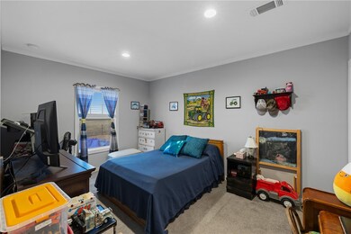 Carpeted bedroom with recessed lighting