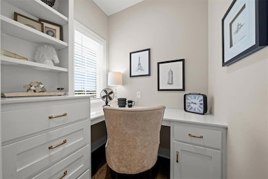 Main floor office with a plethora of built ins. Office has sliding pocket door for privacy. Photos from a previous model. Finishes and colors will not be the same in the final home. 