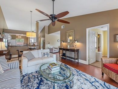 Living room with visible vents, a ceiling fan, cor
