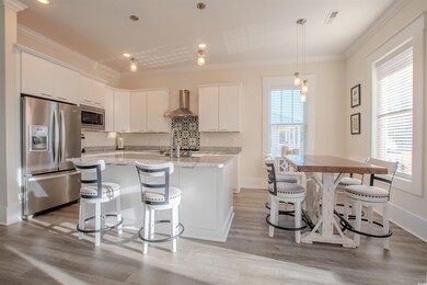 Kitchen with a wealth of natural light, white cabi