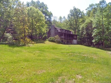 Rear of home with large covered porch and patio. Property is very private and peaceful