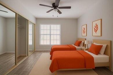 Bedroom with wood finished floors, baseboards, an