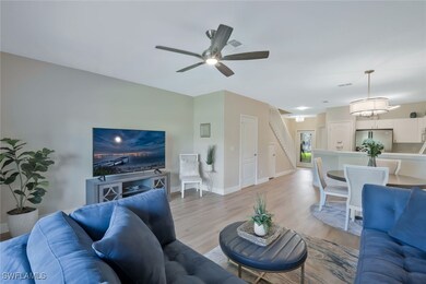 Living area with a ceiling fan, light wood-style f