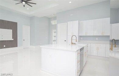 Kitchen featuring white cabinetry, sink, and ceili