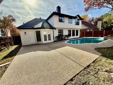 Back of house with a fenced in pool, french doors, and a patio