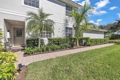 View of exterior entry featuring a yard and stucco siding